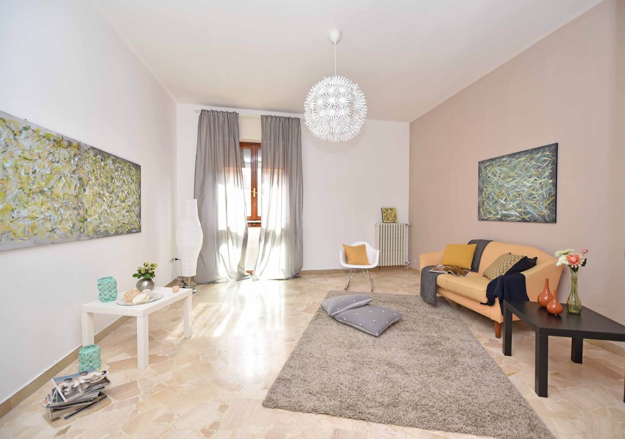Wall decor and wall design ideas in a bright living room with art prints and a modern sofa