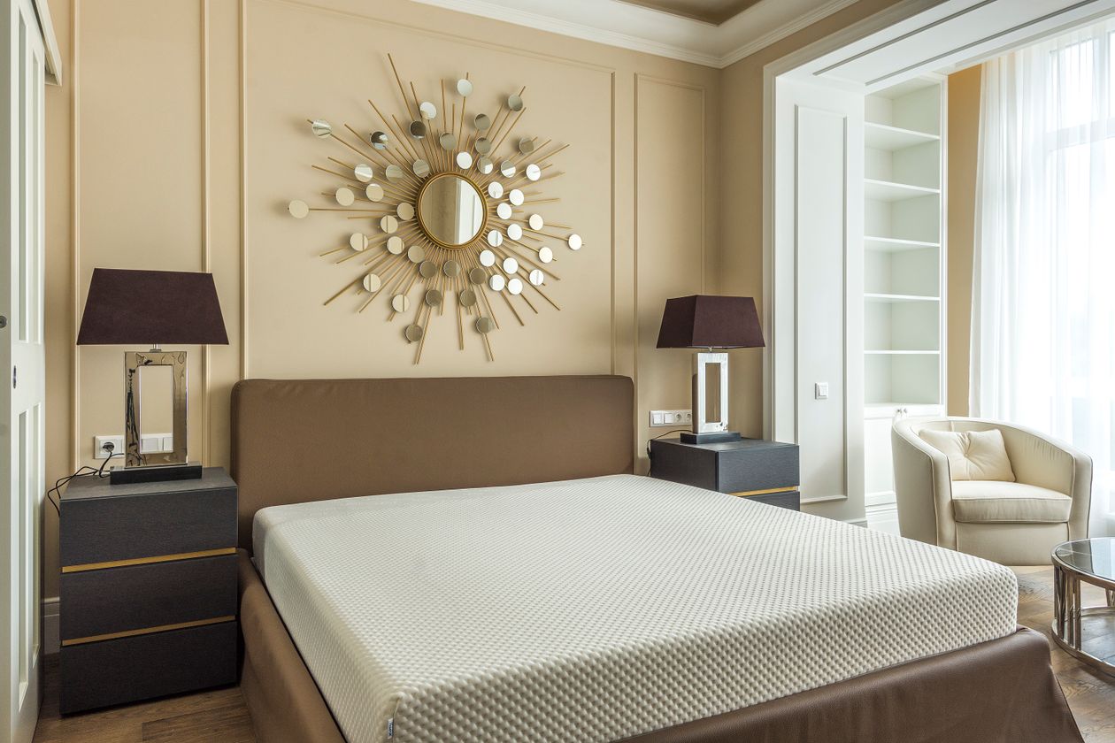 Bedroom wall decor and wall design ideas with a calm sunburst mirror and restful colours